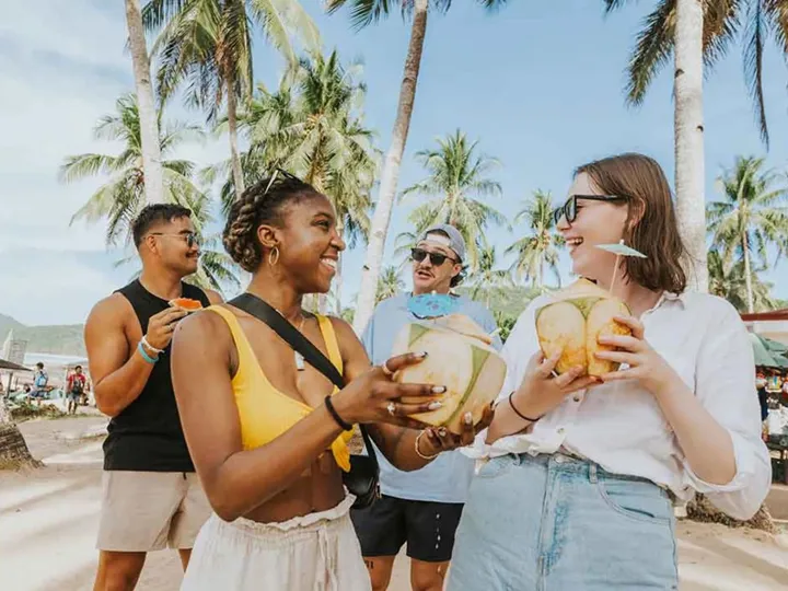 Friends Talking And Drinking Coconut