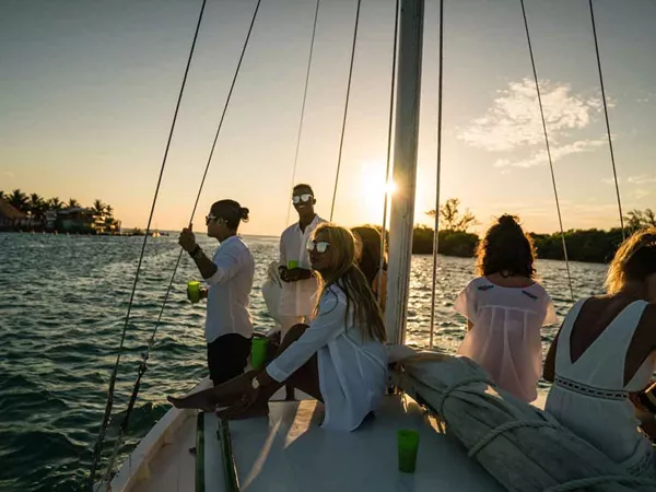Group Of People Enjoying Sunset In A Boat