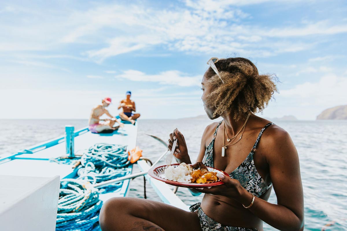 Woman Eating On A Boat