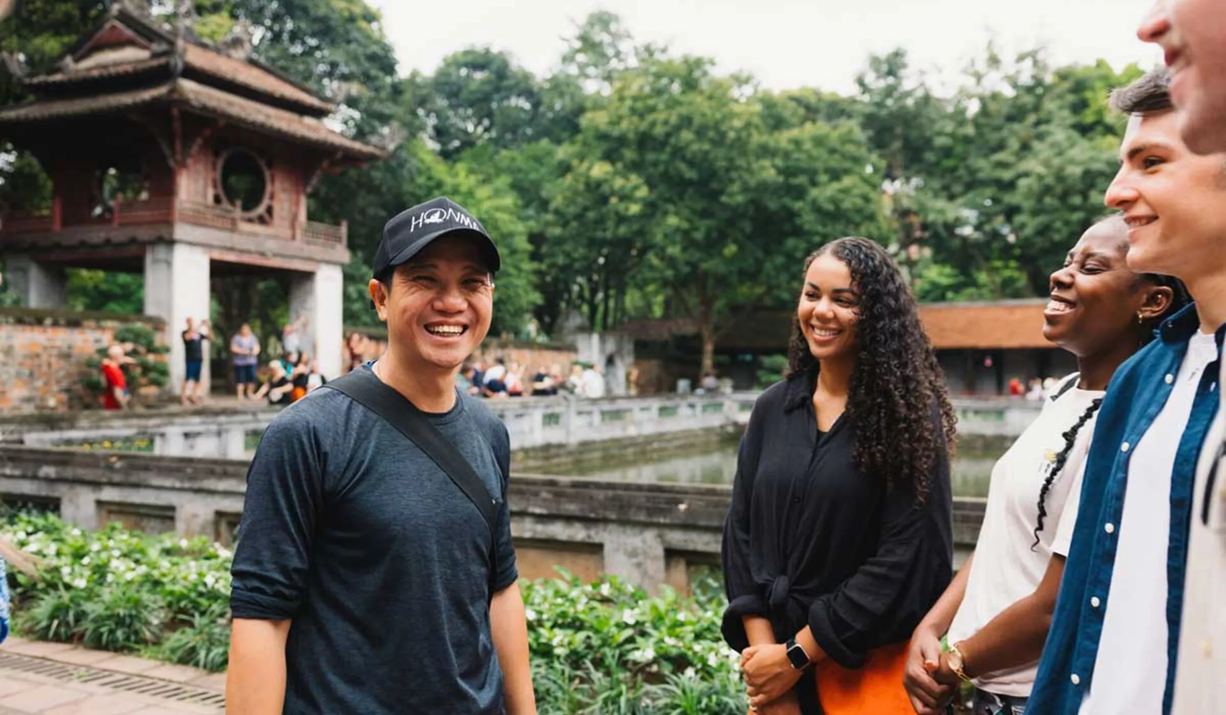 imgi_63_people-smiling-temple-at-the-back-green-trees.jpg