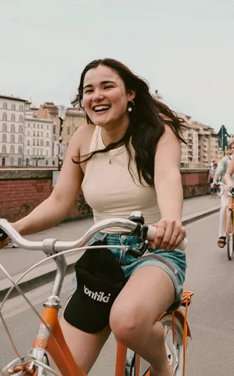 Contiki travellers cycling through the historic streets of Florence, Italy, on the Vienna to London Trail Tour