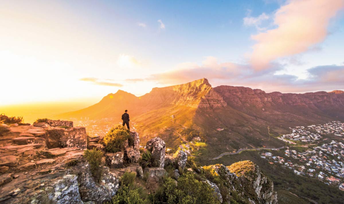 Man At The Top Of Mountains In Cape Town Looking At Mountains