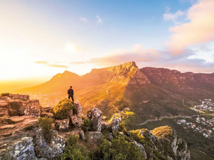 Man At The Top Of Mountains In Cape Town Looking At Mountains