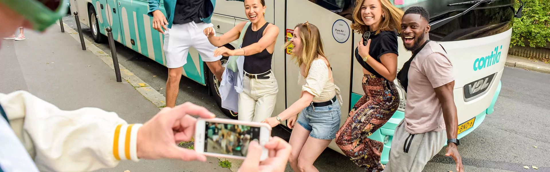 Group Of Young Travelers Having Fun Outside Of A Contiki Coach 2908EURS2022