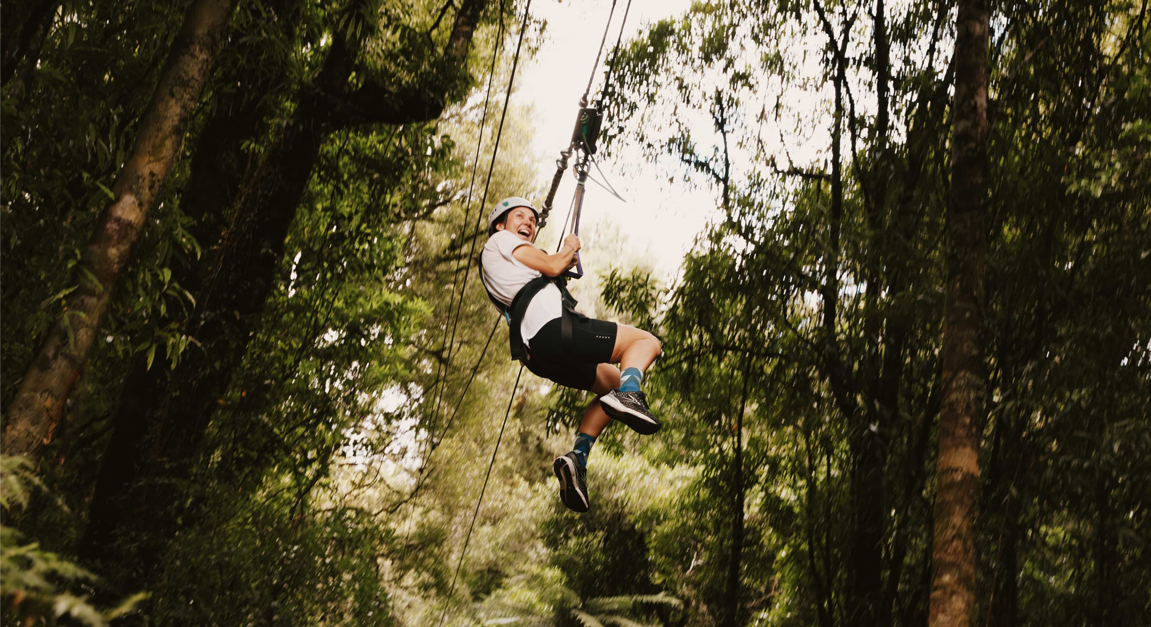 lmdnz-banner-woman-zipline-speed-through-forest-rotorua-newzealand.jpg