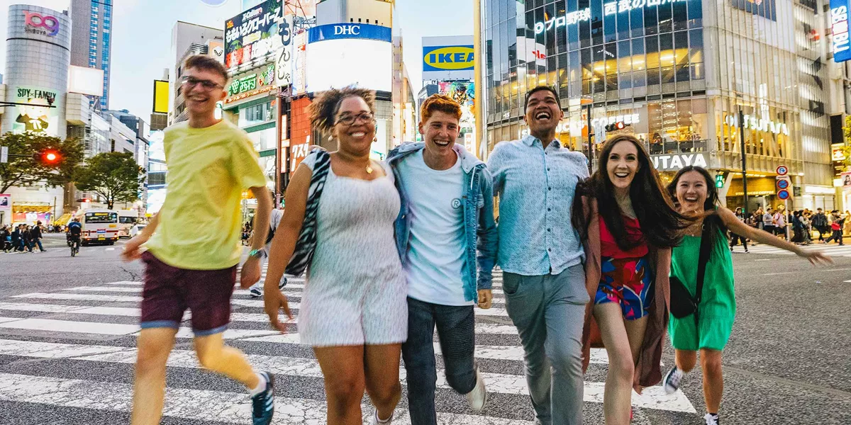 Group Of Young Travelers Exploring Tokyo Japan