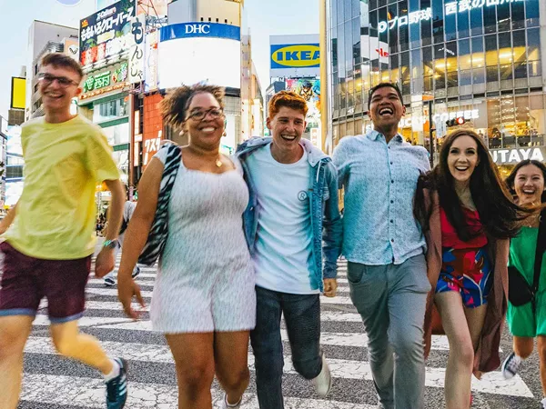 Group Of Young Travelers Exploring Tokyo Japan