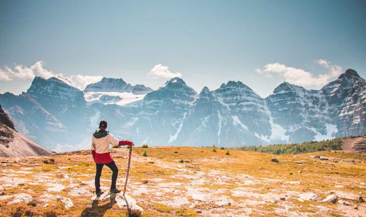 Man Hiking Looking At The Mountains
