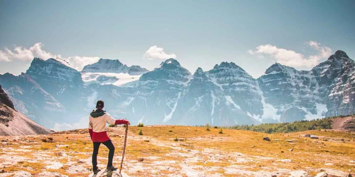 Man Hiking Looking At The Mountains