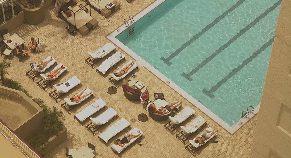 People sunbathing on sunbeds by the pool in hotel in Las Vegas, USA
