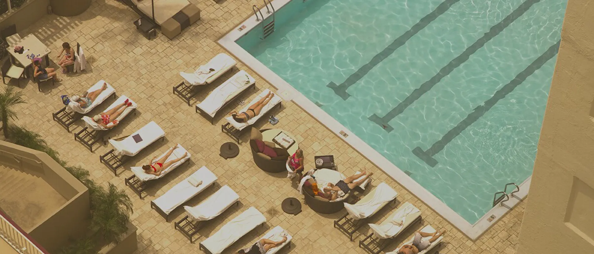 People sunbathing on sunbeds by the pool in hotel in Las Vegas, USA