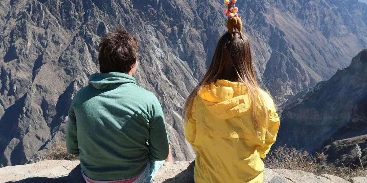 Two People Looking At Rocky Mountains