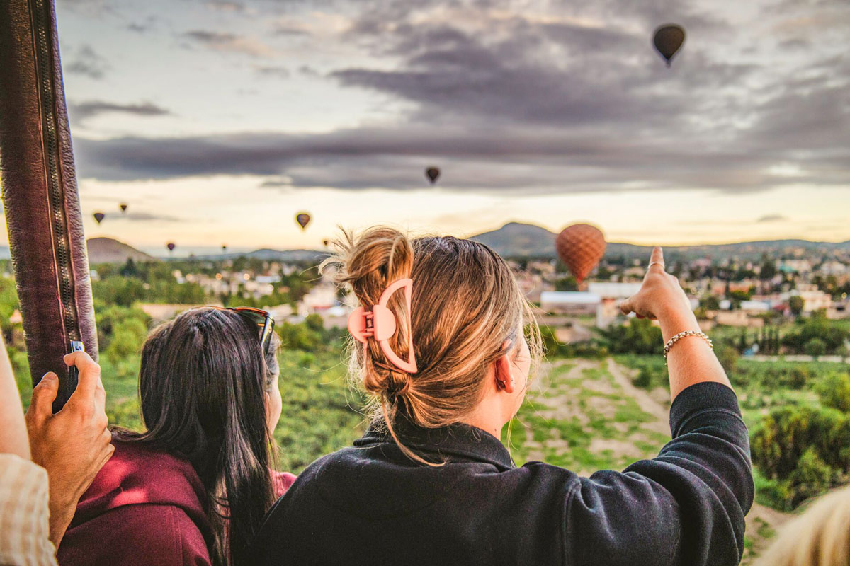 People Looking And Pointing At Hot Air Balloons