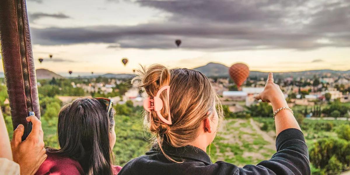 People Looking And Pointing At Hot Air Balloons