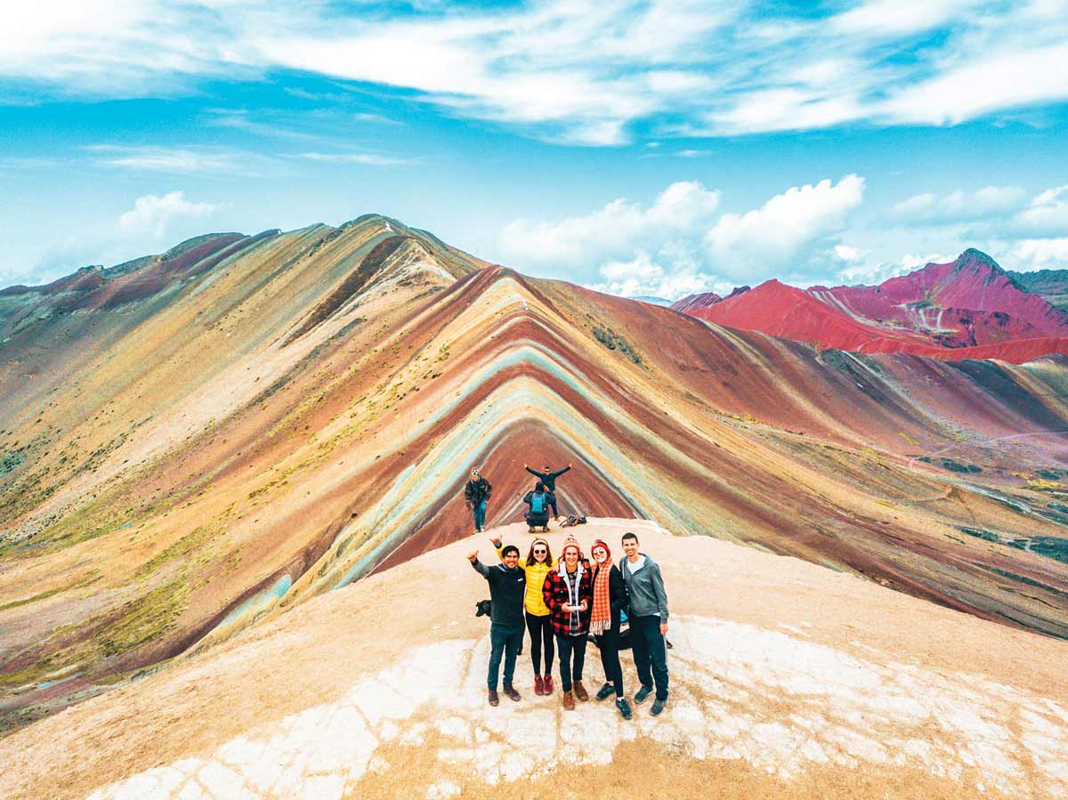 people-standing-rainbow-mountain-at-the-back.jpg