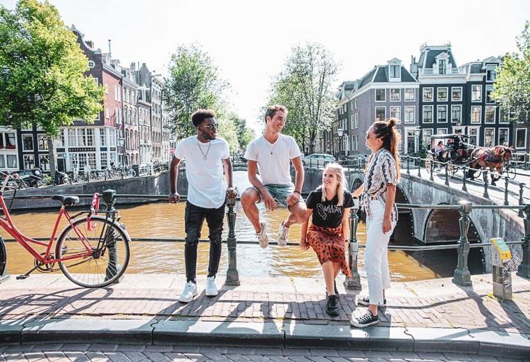 Travellers on a bridge in Amsterdam