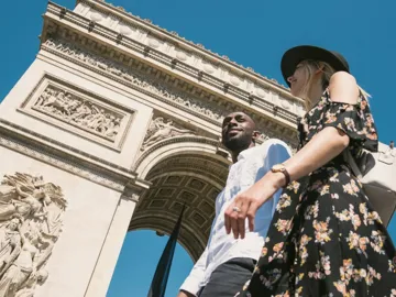 Contiki travellers visiting the Arc de Triomphe in Paris, France, during the London to Berlin by Train Tour, exploring iconic European landmarks and city sights