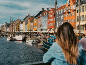 Two girls overlooking Nyhavn harbour in Copenhagen, Denmark - Contiki Best of Scandinavia Tour
