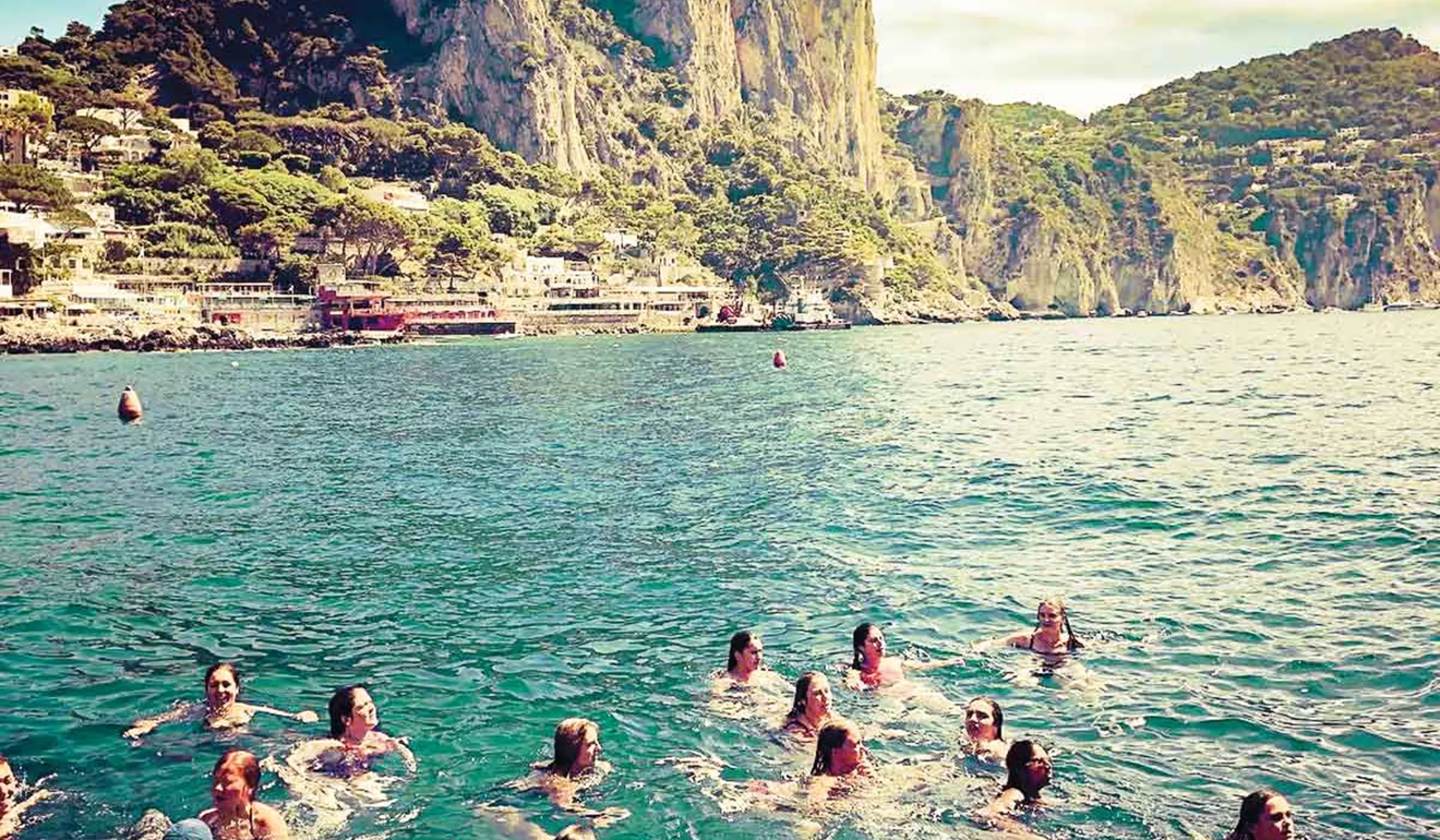 Group swimming in the sea on Amalfi Coast, Italy