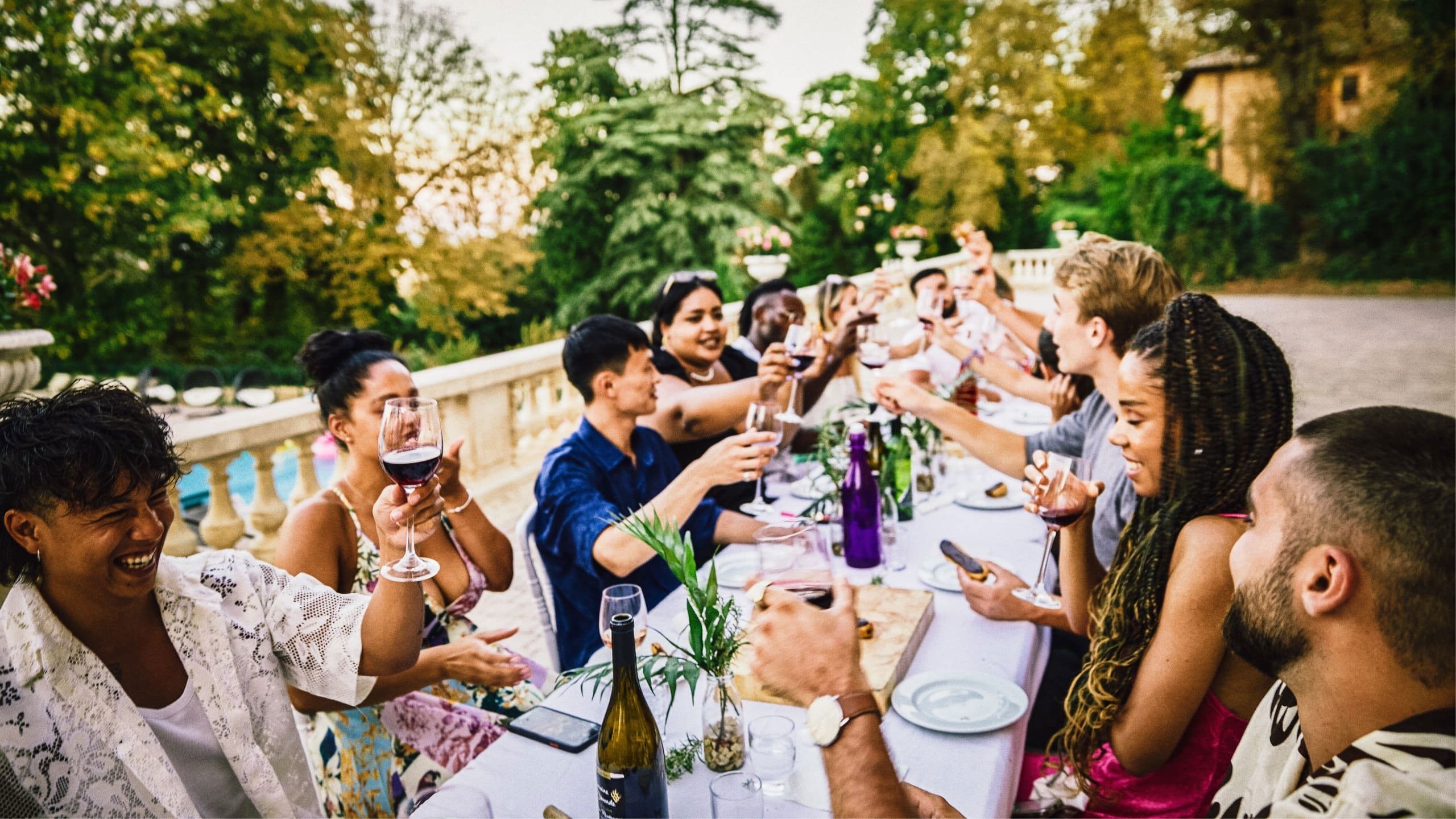 Travellers enjoying food and wine together at a French château on the Contiki Food & Wine in a French Château Tour