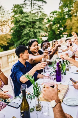 Travellers enjoying food and wine together at a French château on the Contiki Food & Wine in a French Château Tour