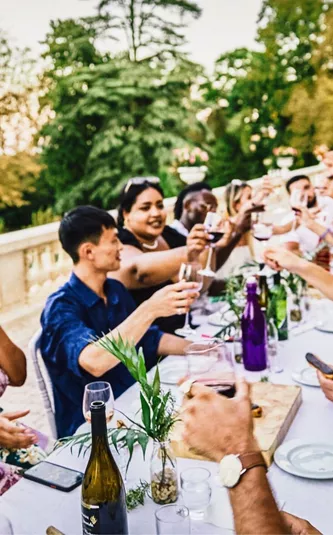 Travellers enjoying food and wine together at a French château on the Contiki Food & Wine in a French Château Tour