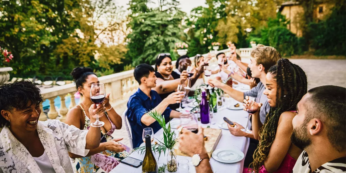 Travellers enjoying food and wine together at a French château on the Contiki Food & Wine in a French Château Tour