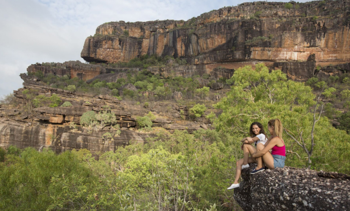 Two Friends Smiling Rocky Mountains Around Them