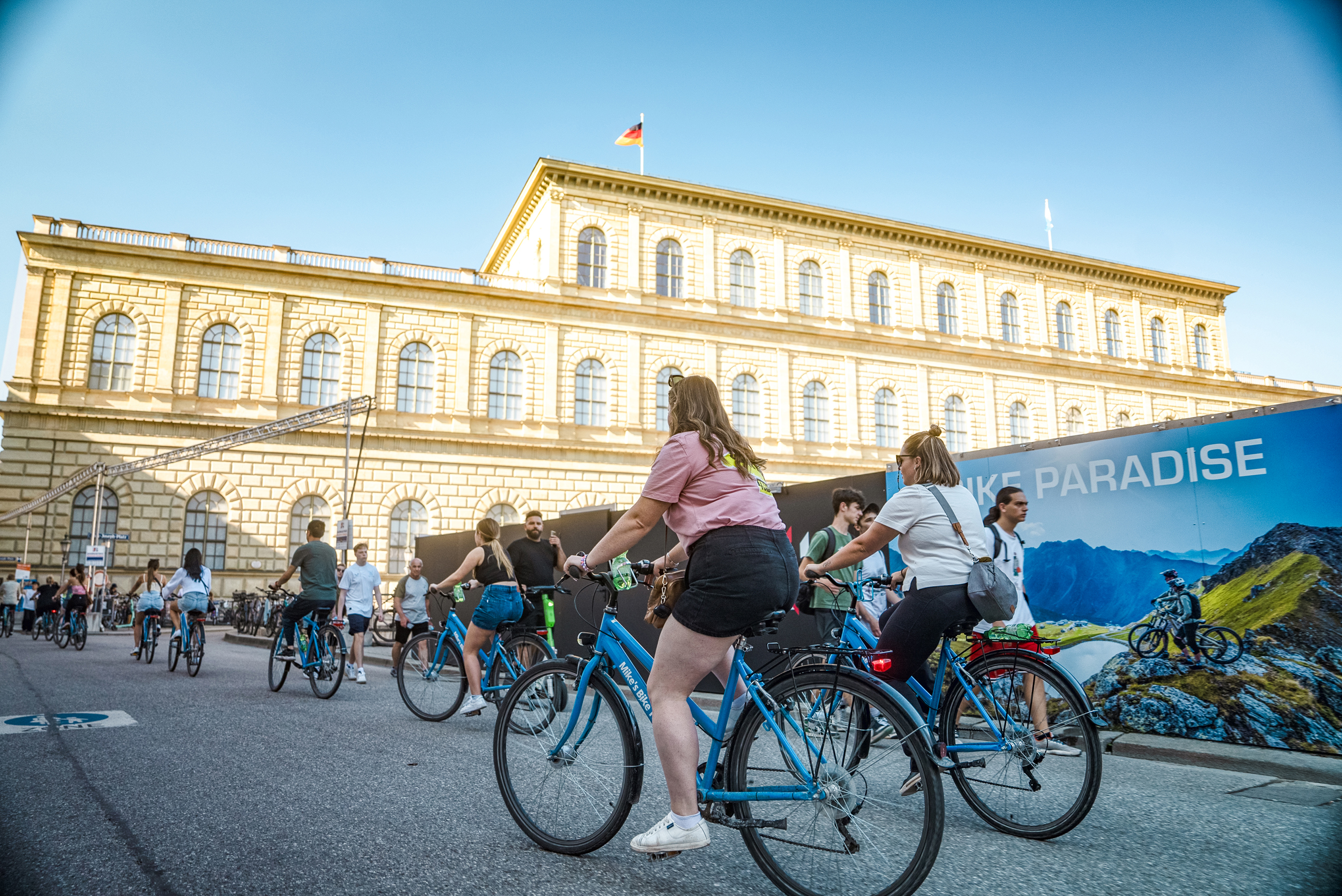 Travellers riding bikes through The English Garden in Munich, Germany 