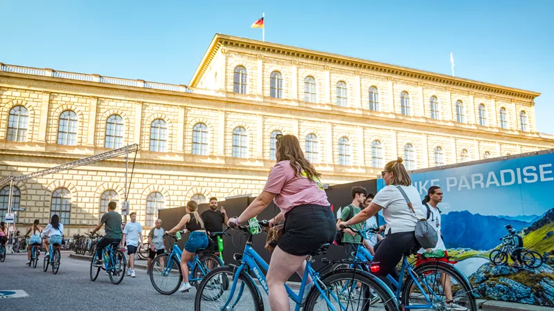 Travellers riding bikes through The English Garden in Munich, Germany