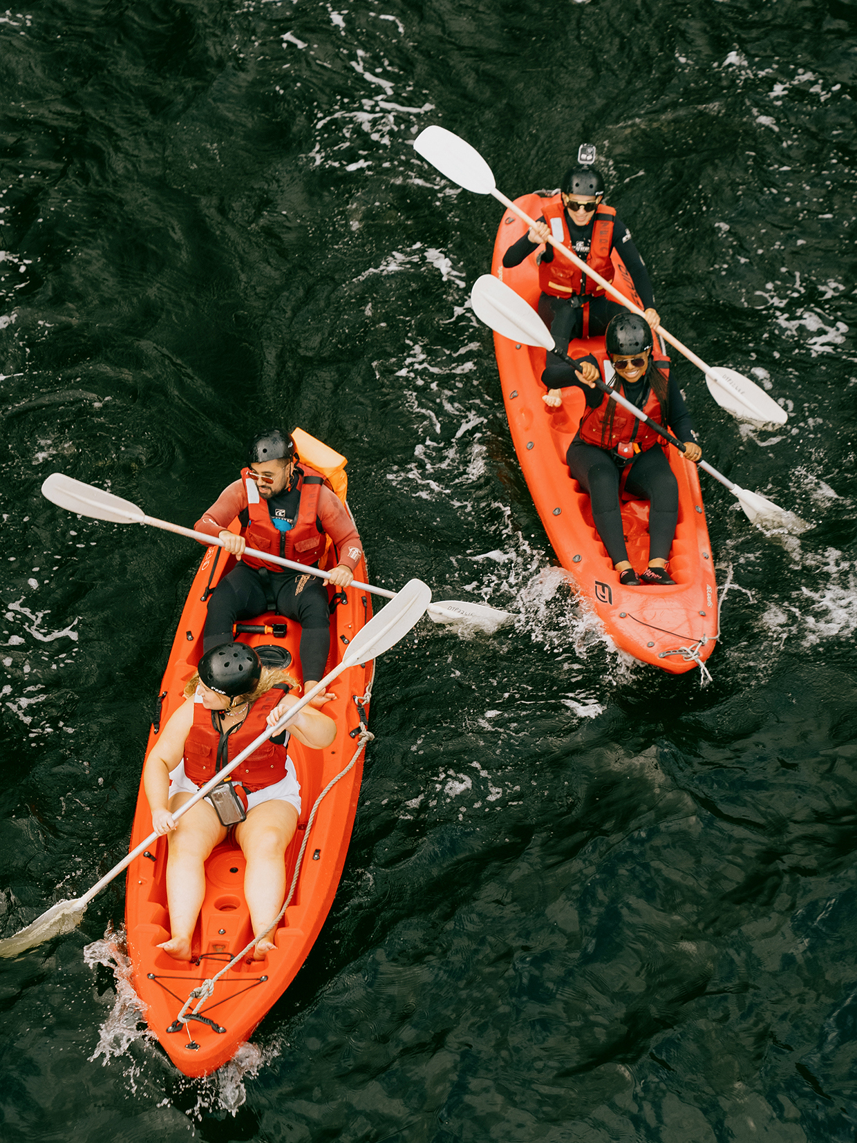 Travellers canoeing in orange canoes on Lake Manyara, Tanzania