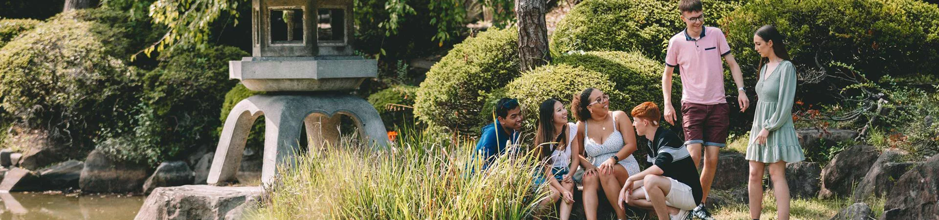 Japan Osaka Group Of Young People Enjoying A Moment In A Beautiful Garden