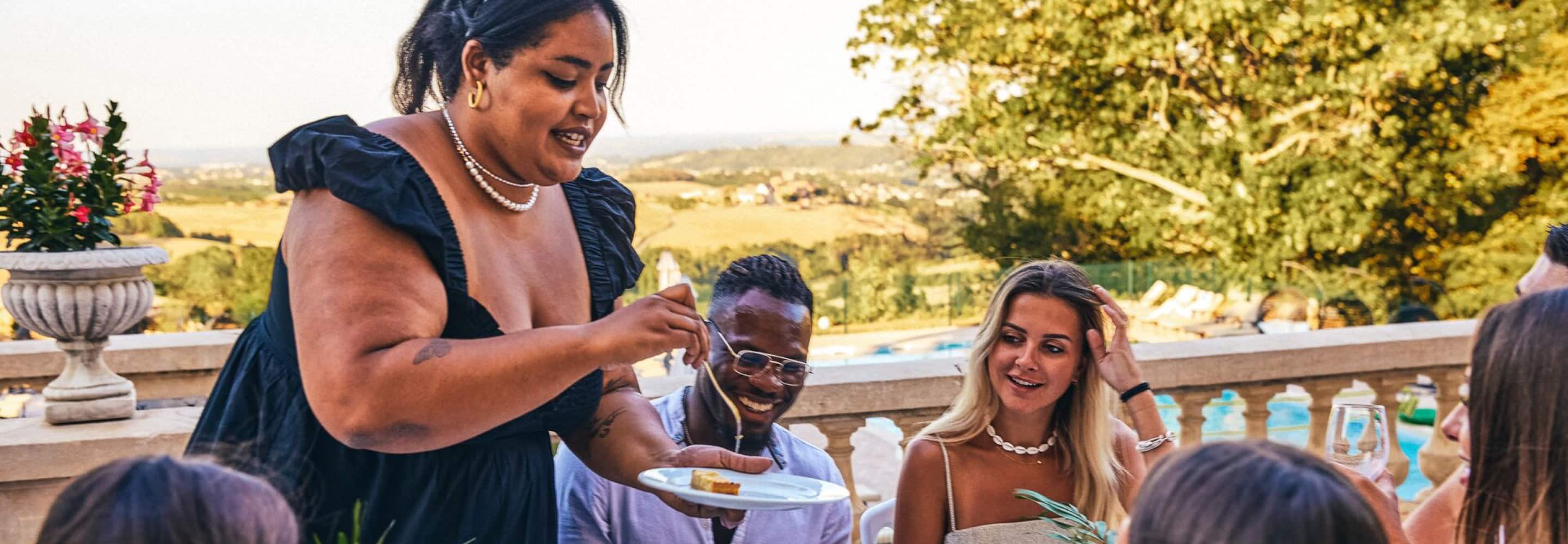 A group of people sitting around a table eating food