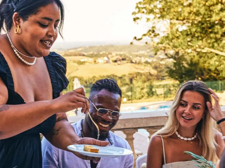 A group of people sitting around a table eating food