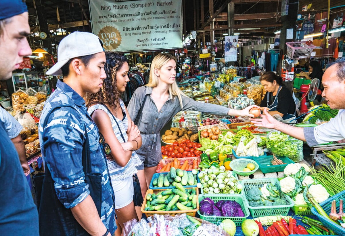 Travellers buying fruits and vegetables in Market in Chiang Mai, Thailand