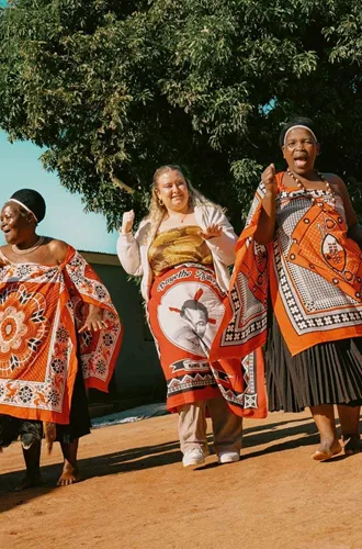 Group join a traditional Swazi dance performance with local community members - Contiki Kruger & Eswatini Safari Tour