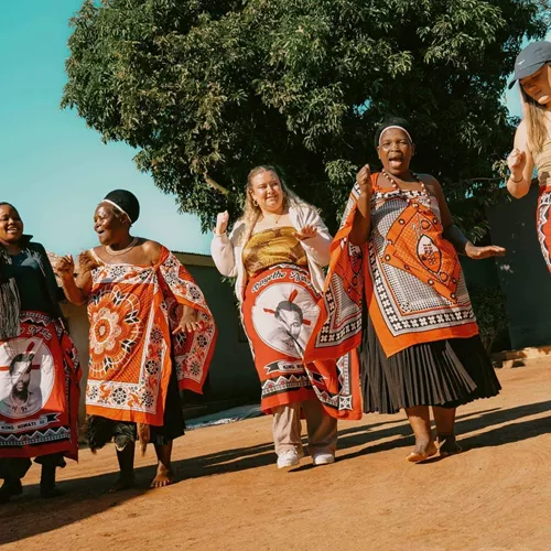 Group join a traditional Swazi dance performance with local community members - Contiki Kruger & Eswatini Safari Tour