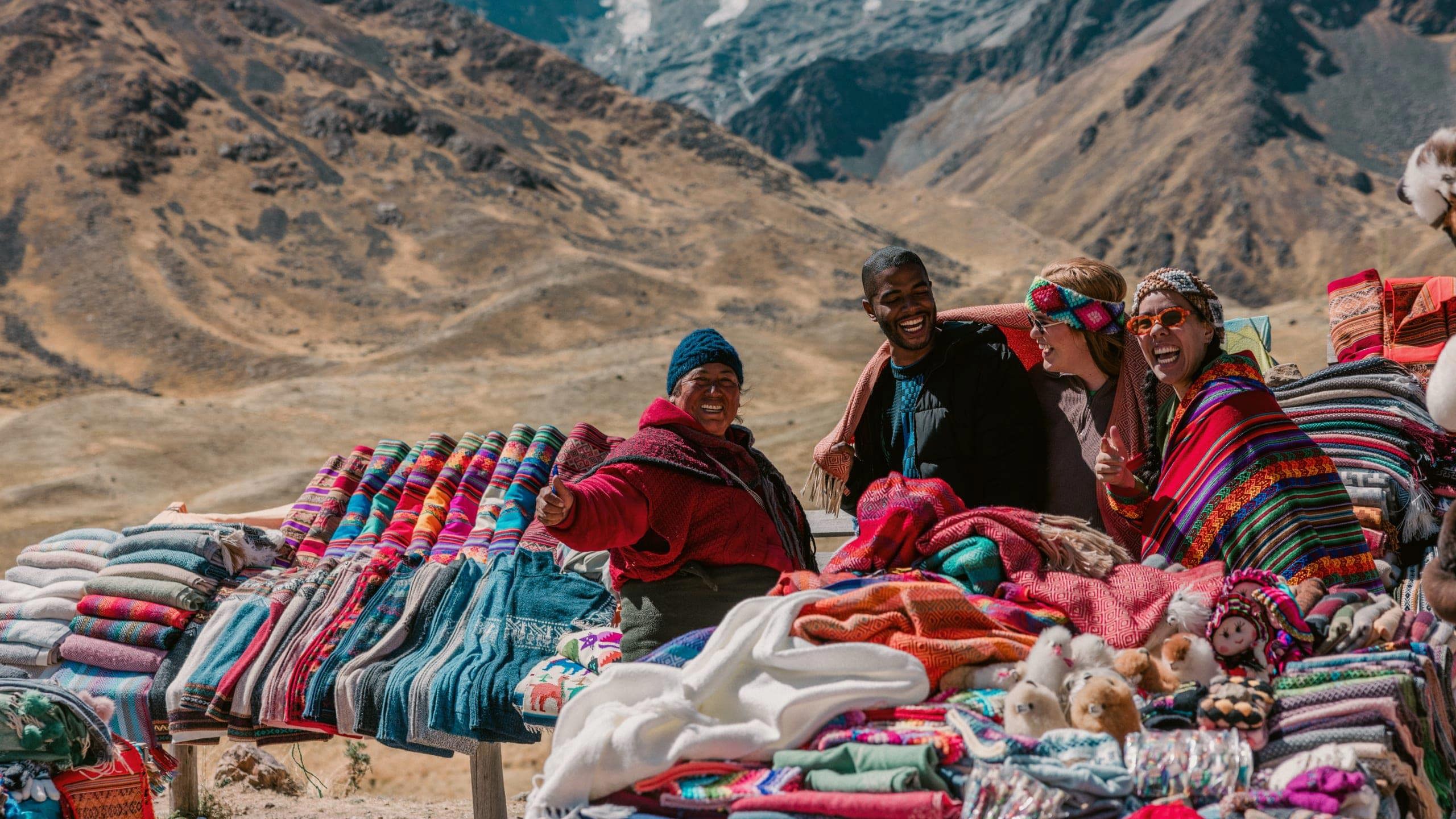 Travellers discovering traditional Andean textiles - Contiki Peru Panorama Tour