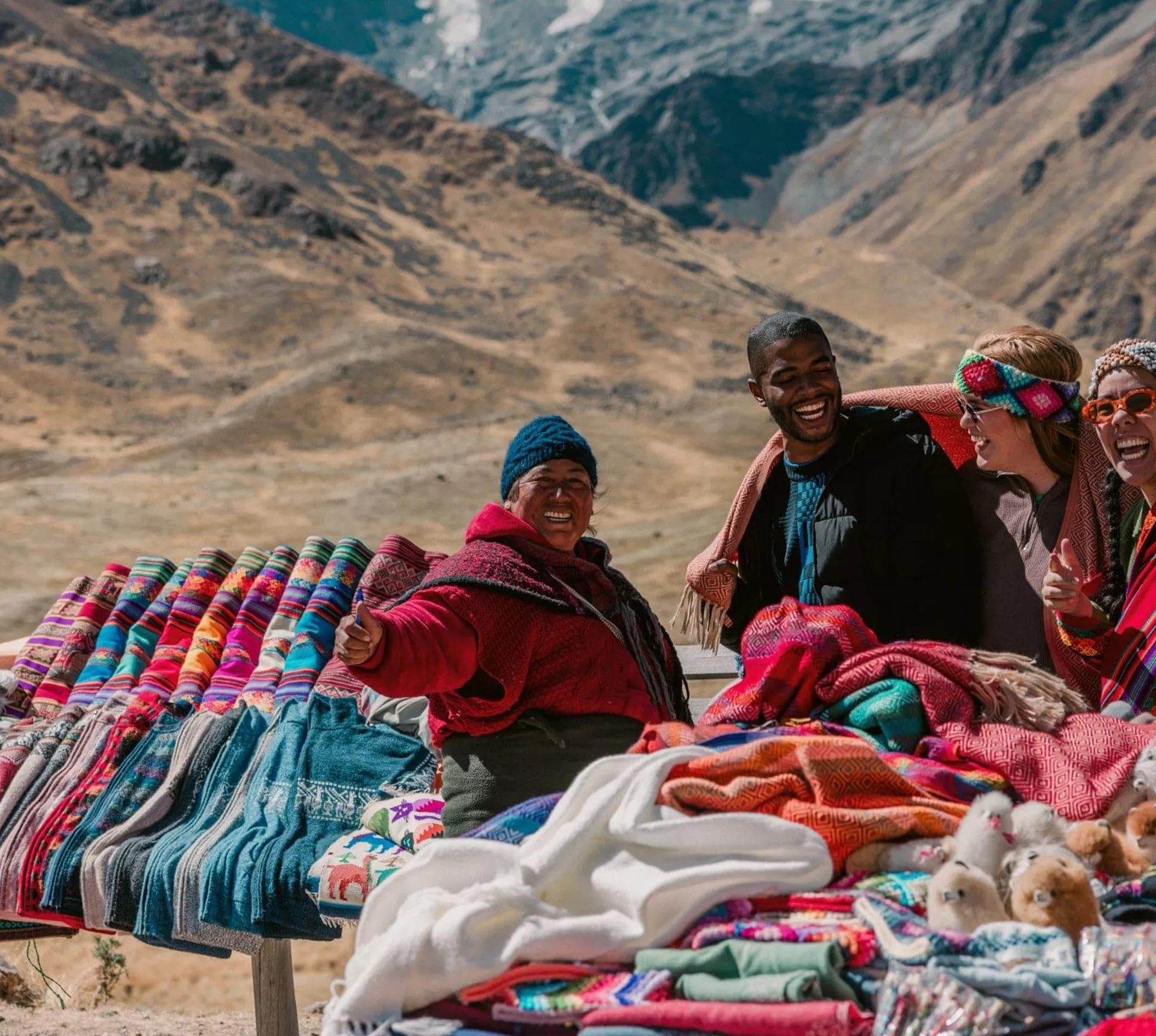 Travellers discovering traditional Andean textiles - Contiki Peru Panorama Tour
