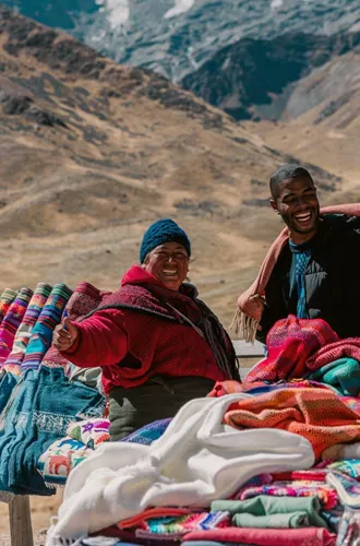 Travellers discovering traditional Andean textiles - Contiki Peru Panorama Tour