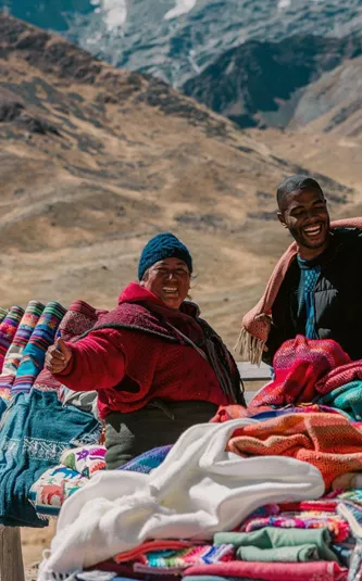 Travellers discovering traditional Andean textiles - Contiki Peru Panorama Tour