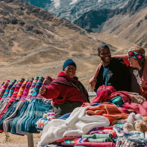 Travellers discovering traditional Andean textiles - Contiki Peru Panorama Tour