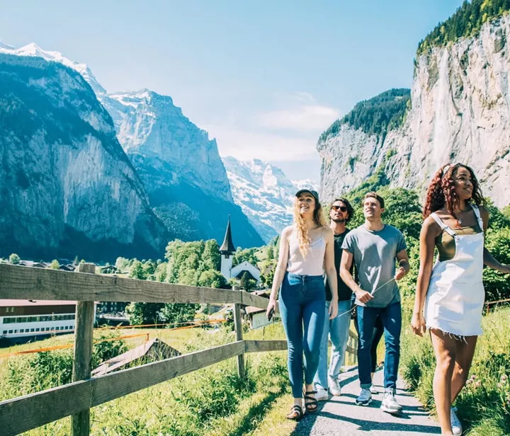 Group of travellers hiking the Swiss mountains