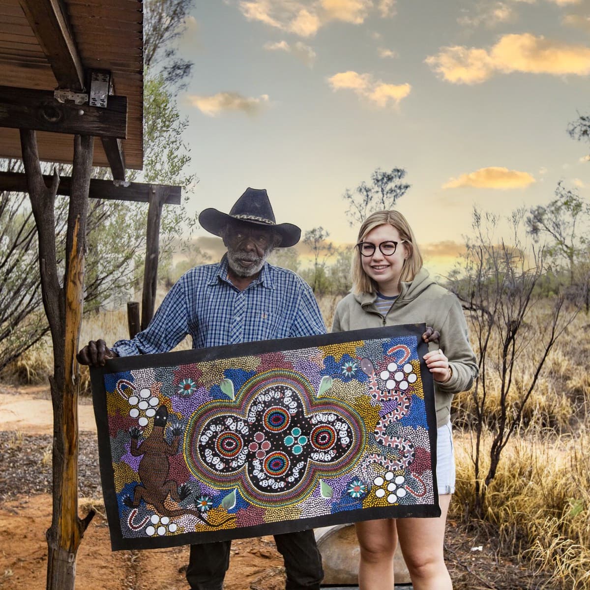Man and woman holding a large decorated cloth