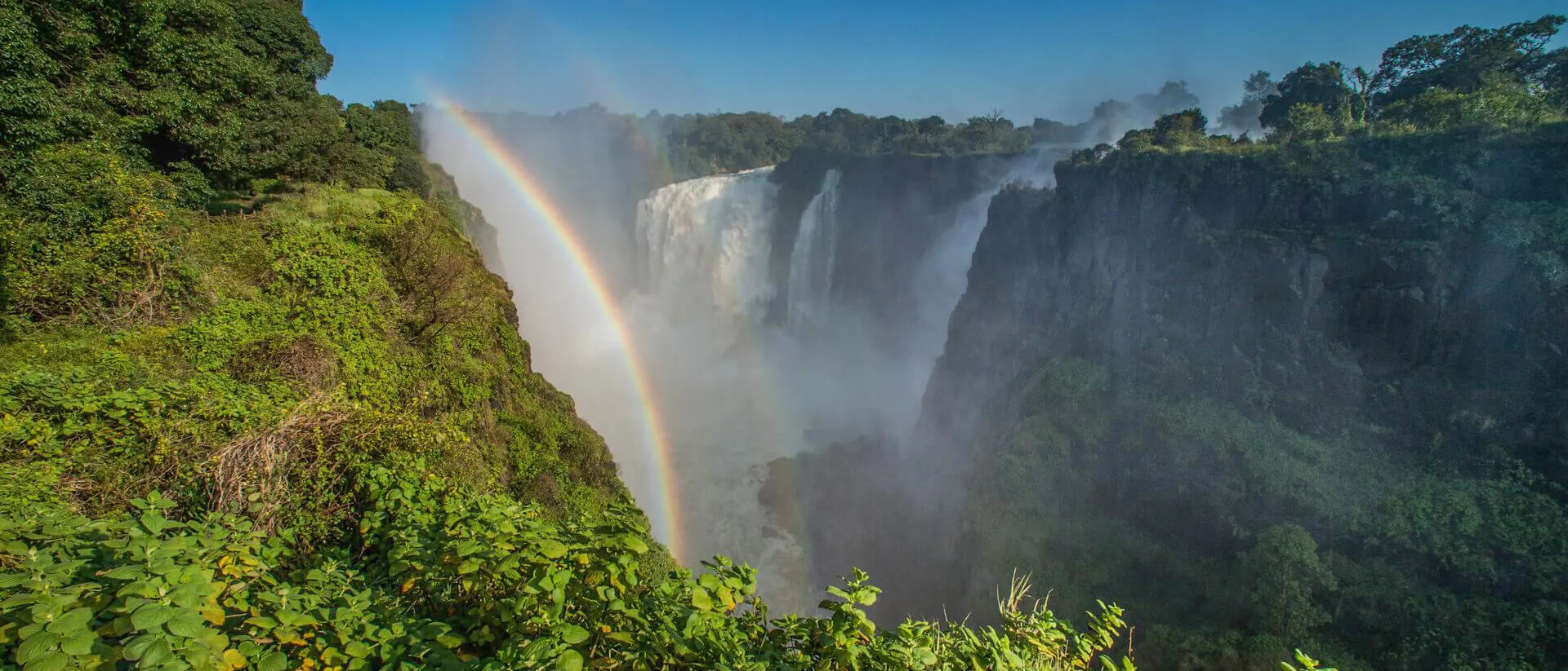 View of Victoria Falls and a rainbow on the sky
