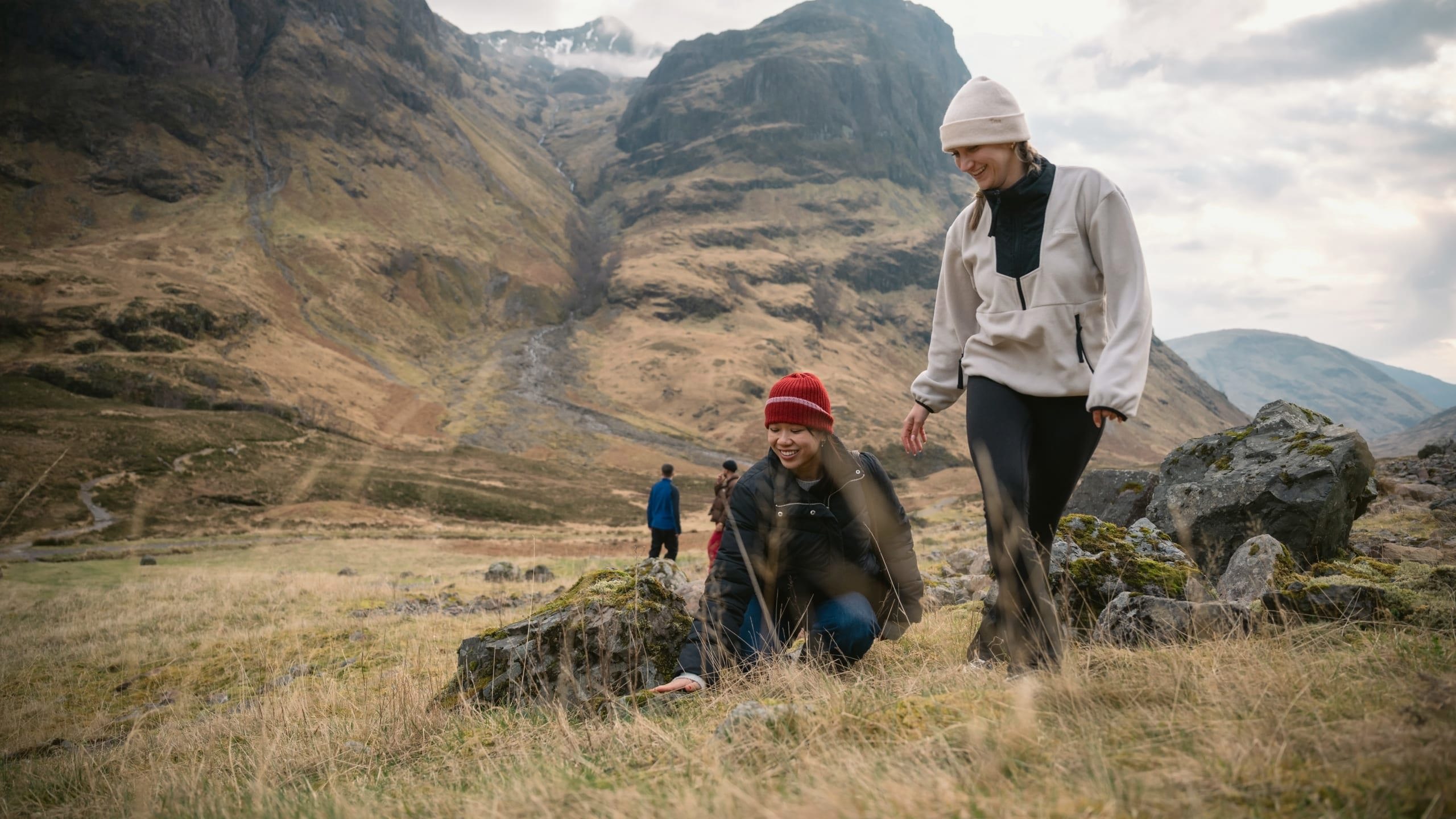 Two people walking through Glencoe in the Scottish Highlands - Contiki Best of Scotland & Ireland Tour