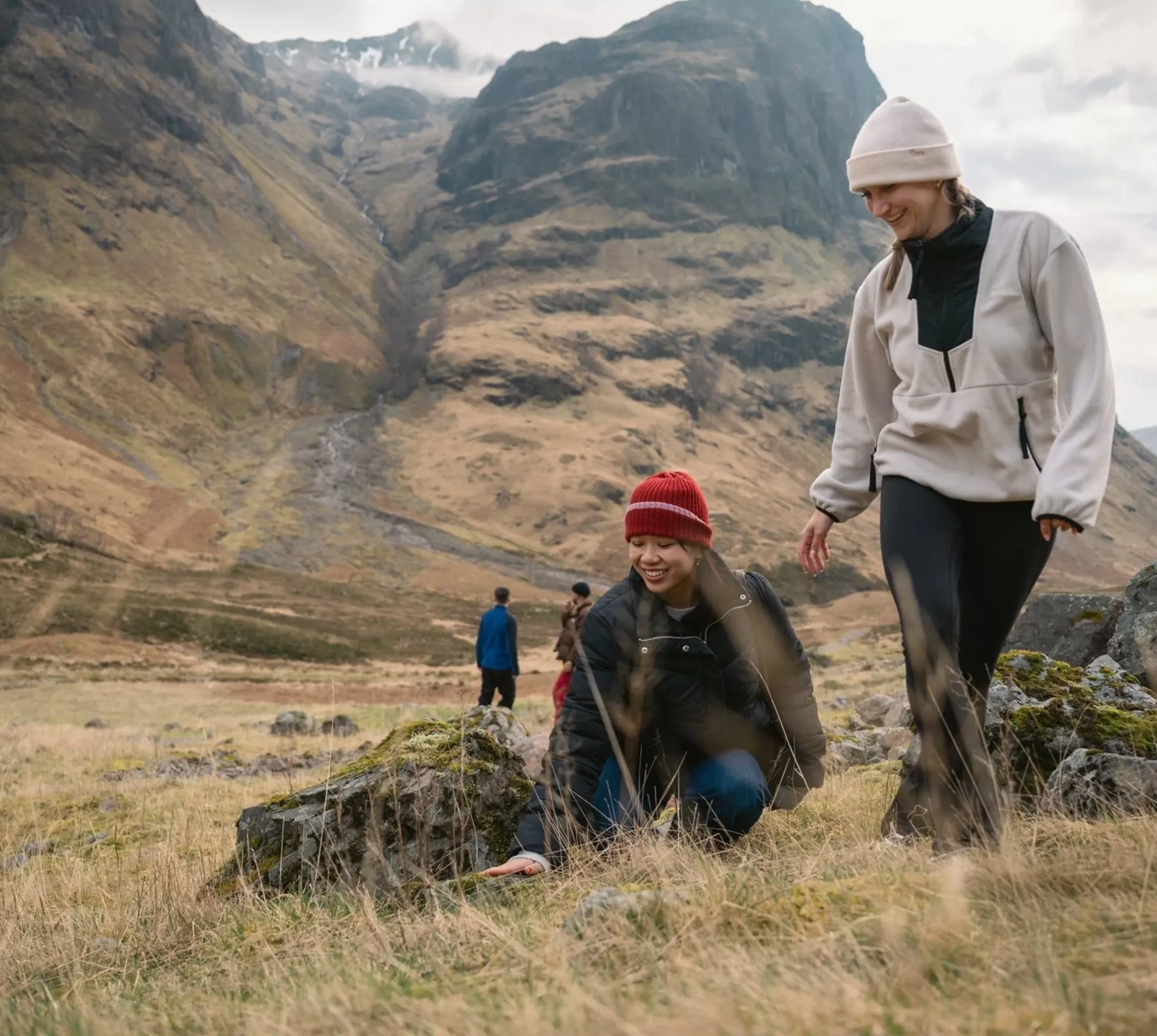 Two people walking through Glencoe in the Scottish Highlands - Contiki Best of Scotland & Ireland Tour