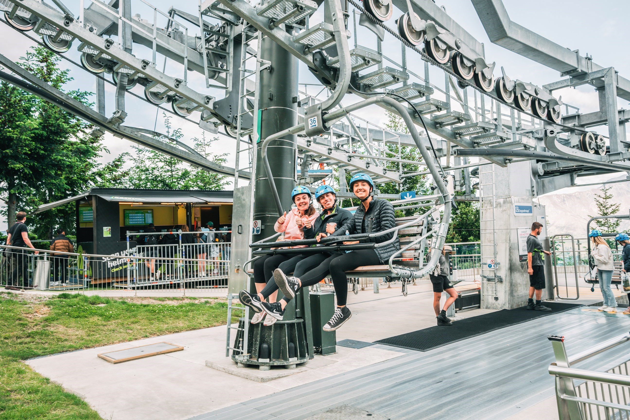 Three travellers sitting on the luge in Queenstown, New Zealand
