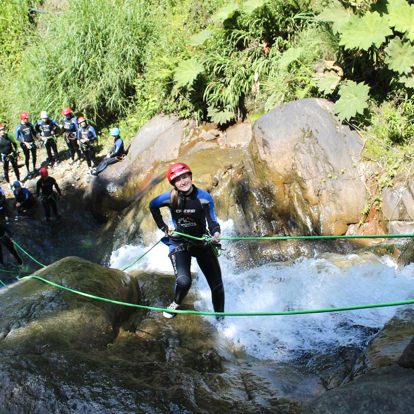 Traveller canyoning at a waterfall in Banos, Ecuador