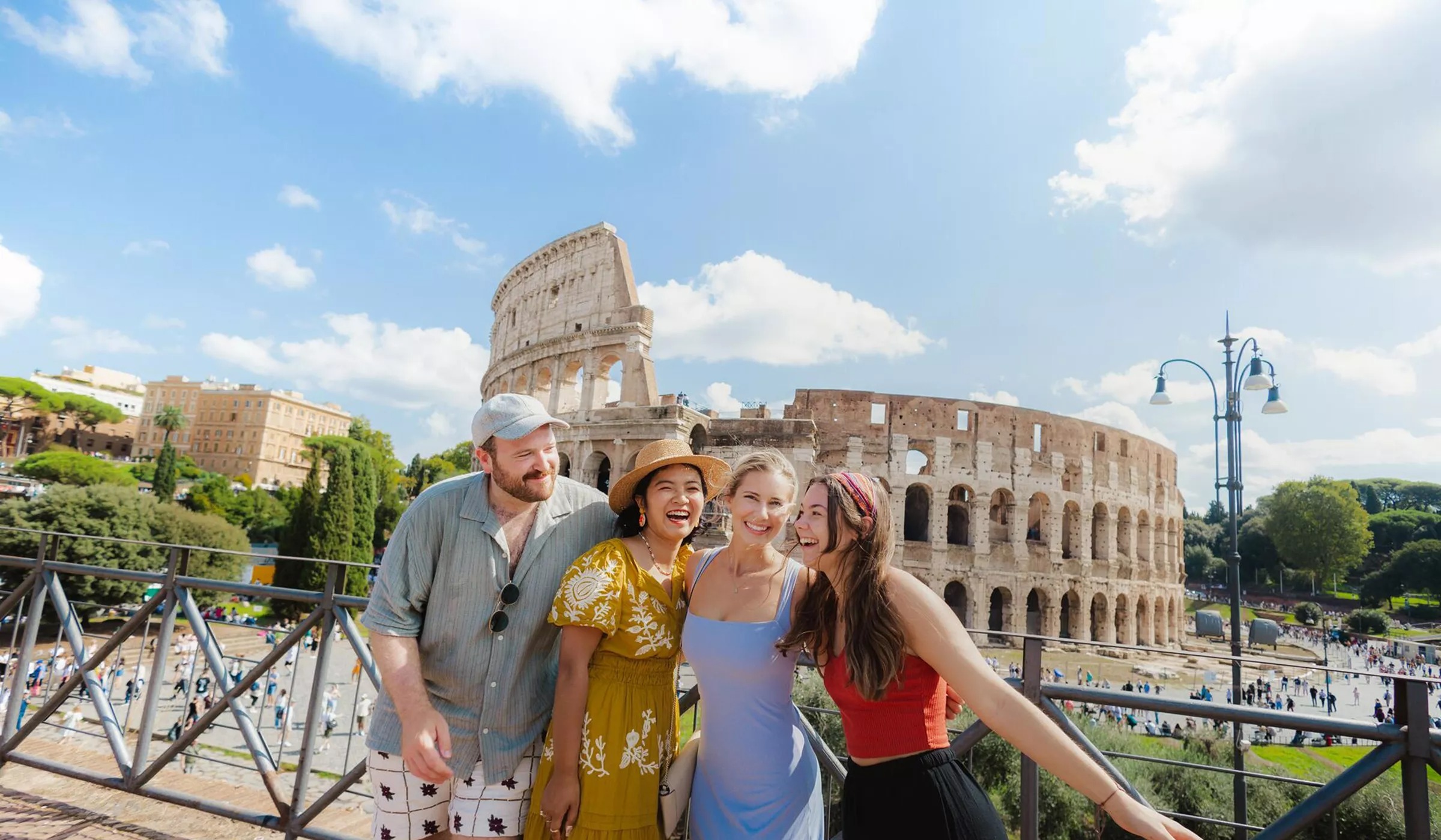 four-friends-smiling-rome-landmark-building-at-the-back.jpeg